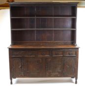 A Welsh oak dresser, probably Denbighshire, the boarded plate rack with cornice and two shelves,