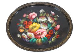 A Toleware oval tray, painted with a bouquet,