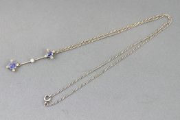 A white metal drop pendant set with cushion faceted cut blue sapphires and old European cut diamonds