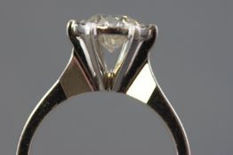 A white metal single stone ring.