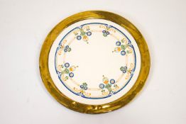 A Burleigh Ware pottery charger decorated in Successionist style within a wide gilt band,