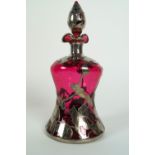 A white metal mounted ruby glass tinted waisted decanter and stopper,