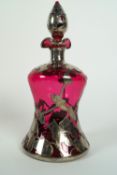 A white metal mounted ruby glass tinted waisted decanter and stopper,