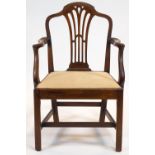A George III mahogany elbow chair with arched top rail above a pierced splat, and scroll arms,