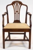 A George III mahogany elbow chair with arched top rail above a pierced splat, and scroll arms,