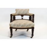 An Edwardian tub shaped chair, the back rail supported on three carved foliate splats,