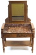 An oak washstand, 19th century, with rectangular bevelled hinged mirror and carved foliate crest,