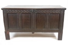 A 17th century oak coffer with quadruple panelled front and later legs,