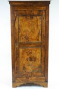 An elm panelled cupboard, the hinged door with two recessed panels, enclosing three shelves,