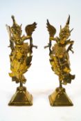 Two brass Balinese dancing figures with winged arms,