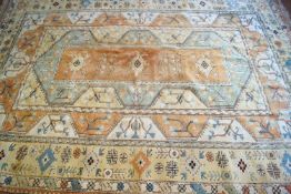 A large carpet with four medallions on a rectangular panel with three wide borders,