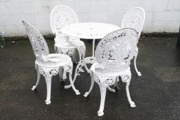 A white painted garden table and four chairs