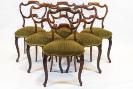 A set of six Victorian rosewood balloon back dining chairs, with pierced cartouche shaped backs,