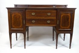 An Edwardian mahogany sideboard, with inverted break front,