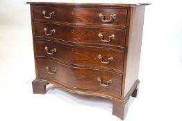 A George III style mahogany chest of four serpentine fronted drawers,