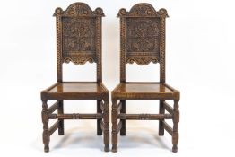 A pair of oak carved hall chairs, in the 16th century style,
