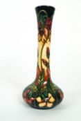 A Moorcroft 'Aquelegia' pattern Limited edition bottle shaped vase, No 76/100, signed R Bishop',
