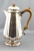 A silver coffee jug, of tapered, ribbed quatrefoil form, with a hinged domed cover,