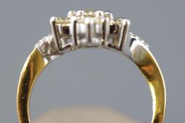 A yellow and white metal cluster ring.