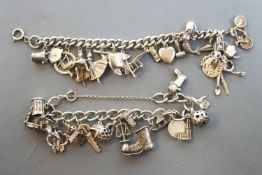 A collection of two sterling silver charm bracelets, each with assorted charms.