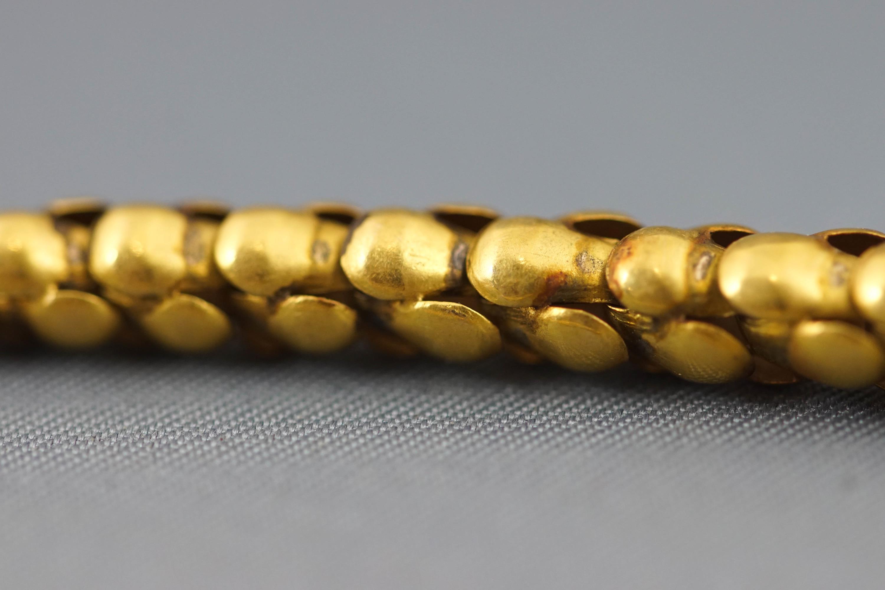 A yellow metal bracelet in the design of a snake. - Image 3 of 3