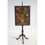 A mahogany adjustable fire pole and tapestry fire screen, on baluster stem and tripod scroll base,