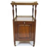 A 19th century mahogany coal purdonium, the two tier top inlaid with a brass gallery,