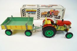 A boxed clockwork Zetor tractor with a detachable trailer and key 29 cm