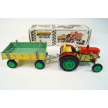 A boxed clockwork Zetor tractor with a detachable trailer and key 29 cm