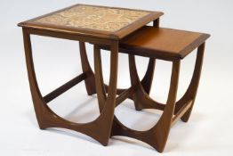 A G-plan style table with tile top, together with another from a nest,