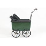 A period painted metal dolls pram finished in British racing green and black,