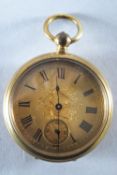 A gold plated open faced pocket watch with gold scroll engraved dial and roman numeral markings.