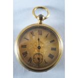 A gold plated open faced pocket watch with gold scroll engraved dial and roman numeral markings.