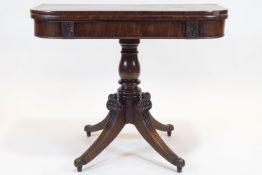 A William IV mahogany turn over tea table, with rounded corners, carved with palmettes,