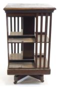 A mahogany revolving square section bookcase, the top with satinwood stringing,