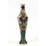 A Moorcroft 'Twilight Orchid' pattern slender vase, designed by Rachel Bishop,