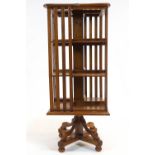 An Edwardian oak revolving bookcase, of square section, with three tiers,