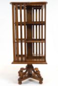 An Edwardian oak revolving bookcase, of square section, with three tiers,