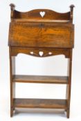 An Arts and Crafts oak bureau, the fall front inlaid with chequered ebony stringing,