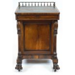 A Victorian rosewood Davenport, with turned gallery above a leather inset sloping front,