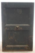 A late 19th century iron safe, with key, the hinged door enclosing two drawers and shelves,