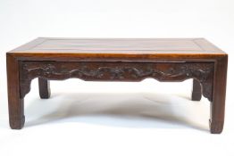 A Chinese rosewood low rectangular table, with scroll shaped aprons,