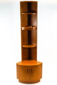 A G-plan teak corner cupboard, with three shelves, one electrified,