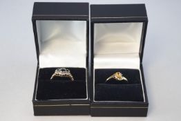 A collection of two dress rings to include: A citrine and diamond crossover;