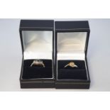 A collection of two dress rings to include: A citrine and diamond crossover;