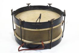 A snare drum, probably military, with brass body,