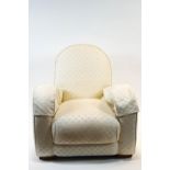 A 1930's armchair, in Art Deco form, upholstered in white on block feet,