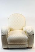 A 1930's armchair, in Art Deco form, upholstered in white on block feet,