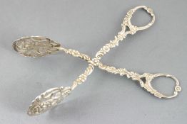 A pair of Continental cast white metal cake tongs, decorated with foliate motifs, 15cm long,