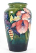 A Moorcroft 'Orchid' pattern green ground baluster vase, early 20th century, printed,